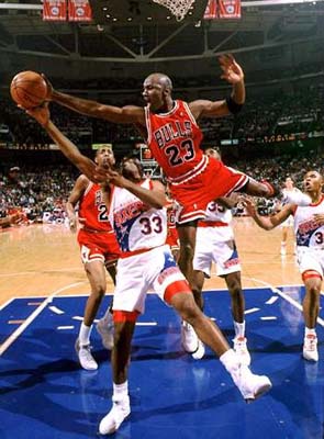 Michael Jordan blocks Hersey Hawkins.